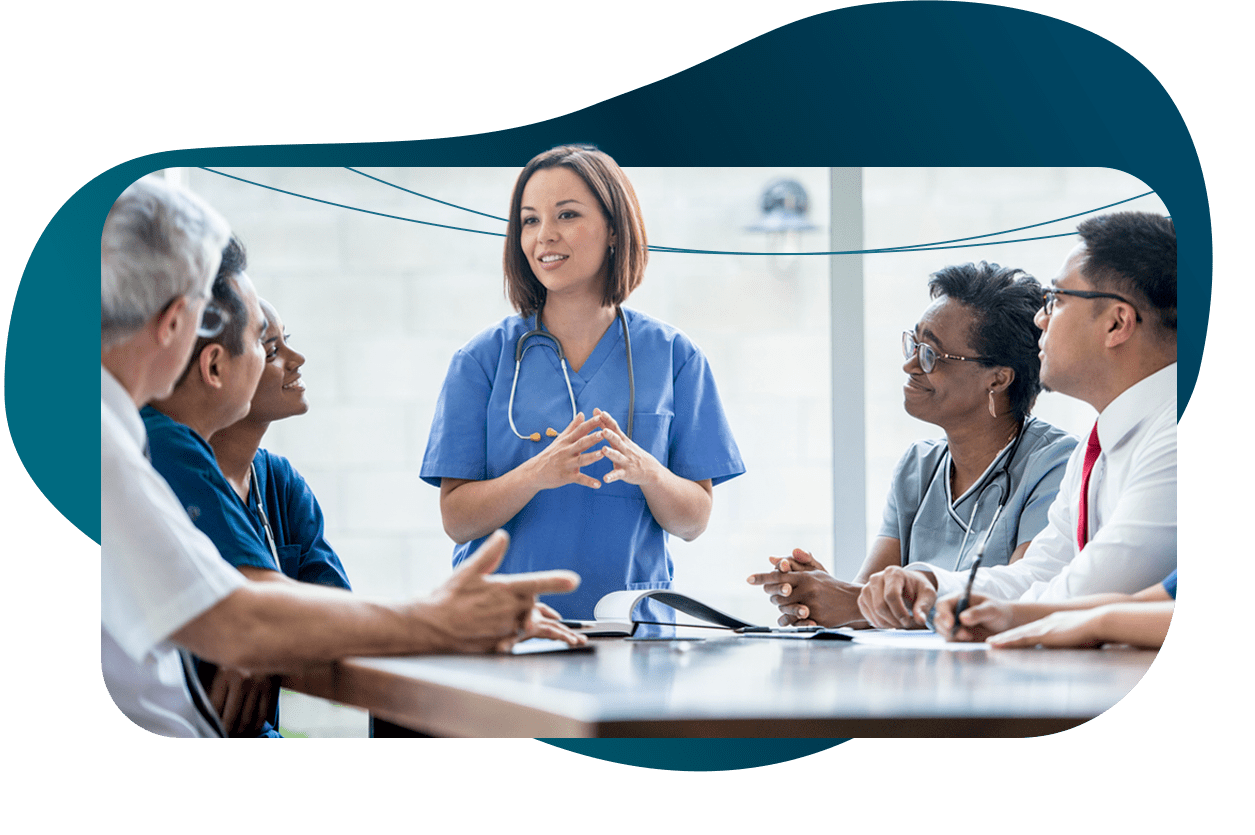 A clinician addresses a room of professionals.